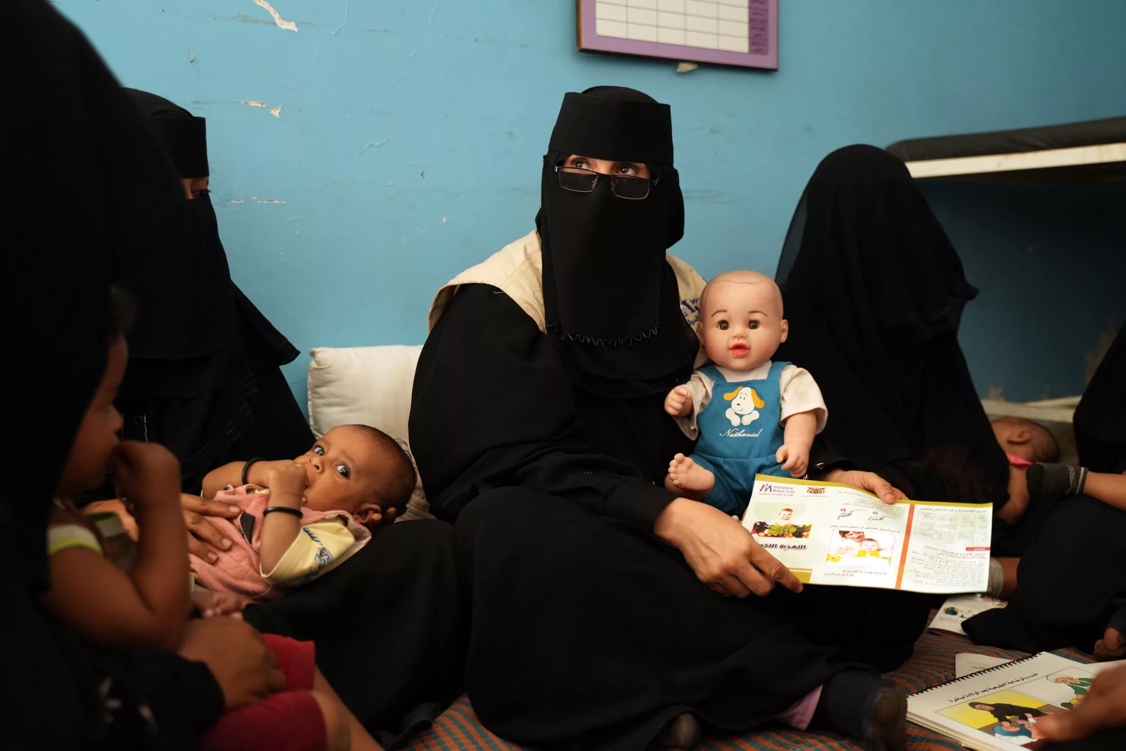 Health worker Hameedah Ali Mohammed Zambeel Hashed teaches mothers about complementary feeding, which involves providing children more than 6 months old with food as well as breastmilk.