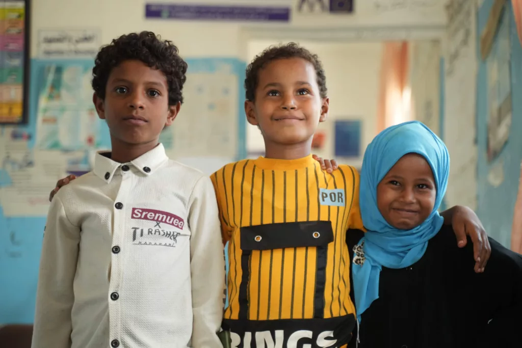 (L–R) 9-year-old Sami Nadmi, 8-year-old Gehad Fuad and 5-year-old Aseel Fuad now know more about personal hygiene and cholera prevention after watching educational videos at the health unit.