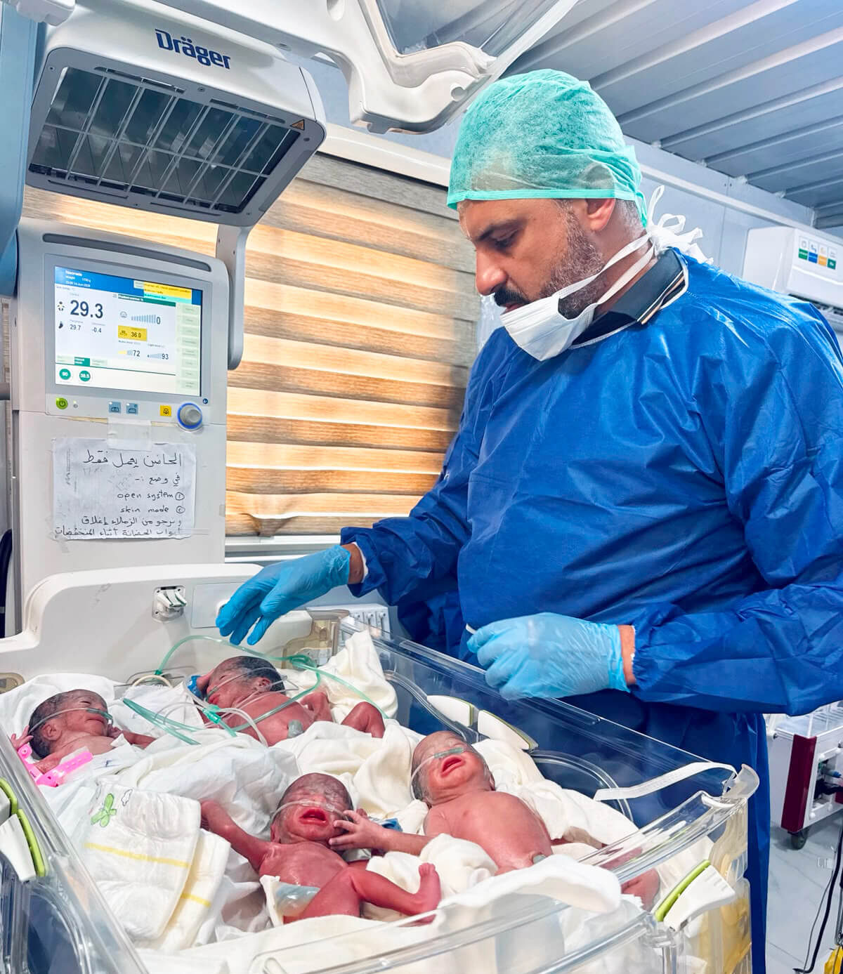 Dr. Mohamed Salam, a consultant pediatrician, examines quadruplets born at the Deir al Balah field hospital.
