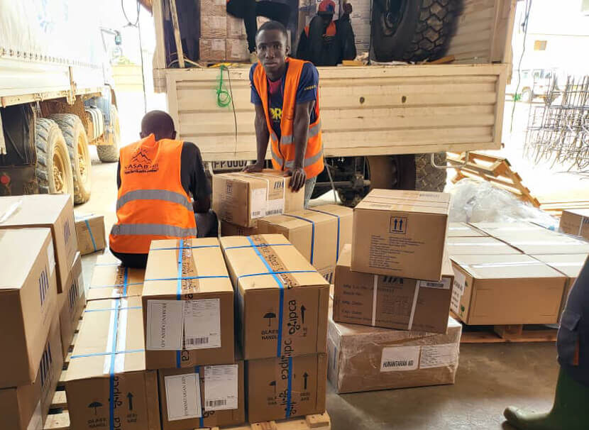 Workers unload PPE supplies in Bunia.